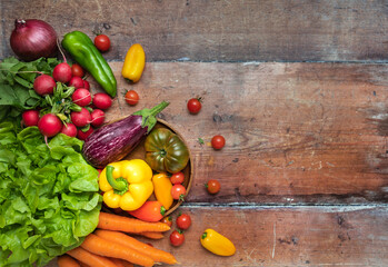 Fresh seasonal vegetables on a wooden background - top view and copy space