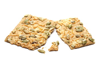 Crispbread with Gouda cheese and pumpkin seeds isolated on white background