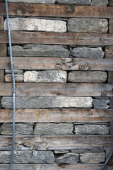 Wooden and stone masonry. Mixed abstract background texture.