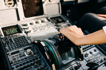 Pilot hand on airplane engine controller in cockpit.