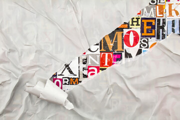 Torn and peeling grey paper on colorful collage from clippings with letters and numbers background.