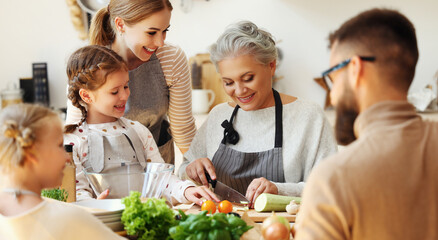 Happy family preparing healthy food in home kitchen.