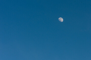 The moon in the blue sky