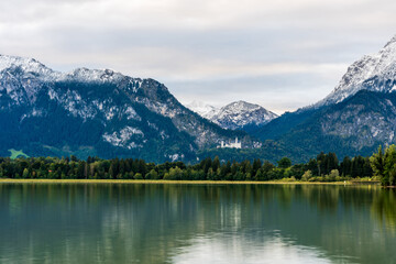 Fototapeta na wymiar Amazing views from the Forggensee lake in Germany with view of neuschwanstein castle 