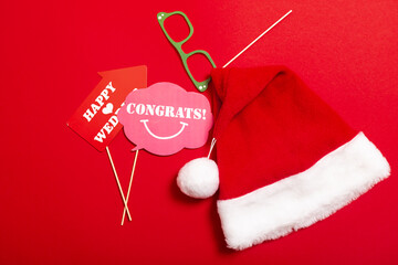 Red banner with a Santa hat with a white pompom and a face from glasses and mustache. A props for...