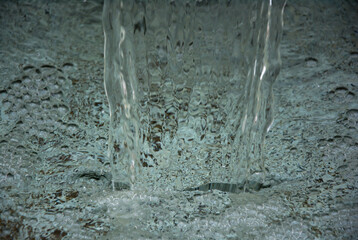 Fountain of waterfall on white stones