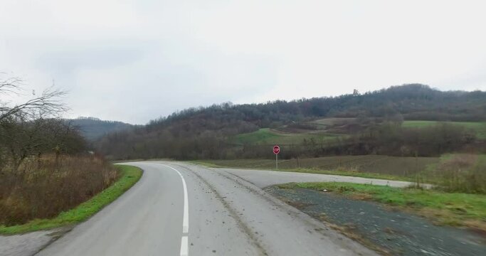 Driving on a winding road covered with mud caused by a muddy tractor.
