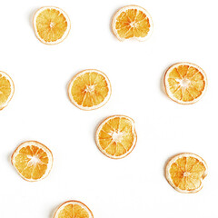 Obraz premium Colorful fruit pattern of dried oranges on white background. Top view, flat lay. Minimal and creative composition.