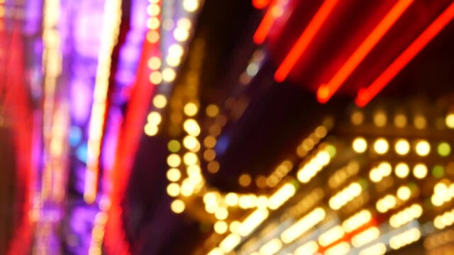 Defocused old fasioned electric lamps glowing at night. Abstract close up of blurred retro casino decoration shimmering, Las Vegas USA. Illuminated vintage style bulbs glittering on Freemont street.