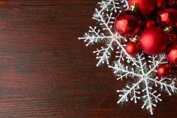  Red Christmas toys with white snowflakes on a brown wood background