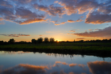 scenic sunset behind the river Delme at Delmestau (Germany)