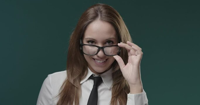 Attractive young woman adjusting her glasses