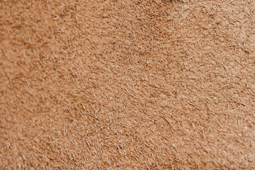 Natural brown suede leather background. Closeup. Selective focus. Copy space.