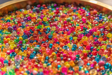 Fototapeta na wymiar A very colorful background of sparkling beads