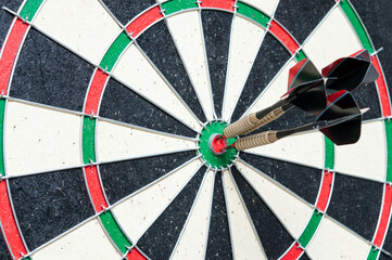 Three Darts hit the center. Space for text.