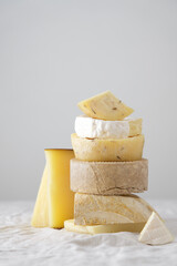 Various kind of cheese served on wooden board, traditional pieces of Spanish, French, Italy cheese....
