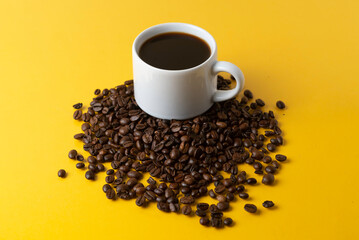 cup of coffee with grains and yellow background