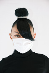 Girl in a white medical mask on a white background