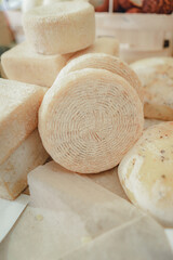 Different cheese in packs and in bulk on market counter