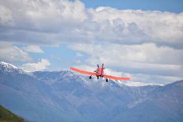 Obraz na płótnie Canvas The view of mountains with an airplane in Queenstown, New Zealand