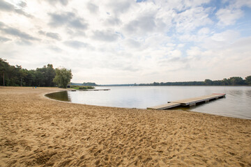 Large lake, clean beach with no people, tourist season, summer