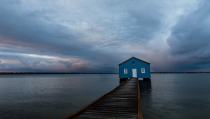 Blue boat shed on a rainy morning on the Swan River in Perth, Western Australia