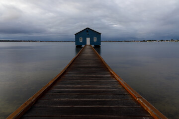 Blue boat shed on a rainy morning on the Swan River in Perth, Western Australia