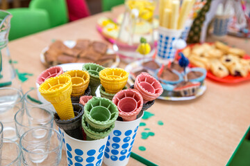 Children's party, lots of sweets, candy, cookies and fruit, colorful table