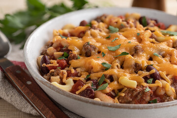 Bowl of chili mac with cheddar cheese