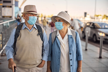 Aged woman staring at her husband with a walking cane