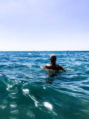 Woman back in the blue sea background