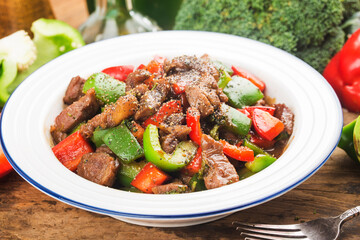 A plate of fried beef cubes with green pepper