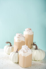 Fototapeta na wymiar Pumpkin spice latte, with decorative little pumpkins