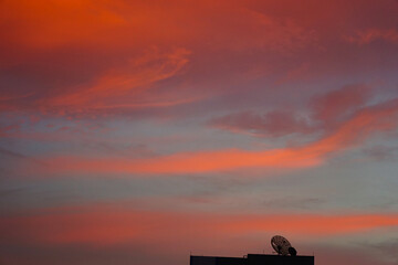 Selective focus on silhouette of satellite dish with twilight beautiful sky background