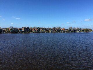 Obraz premium landscape of city view near sea coast at blue sky in Zaanse Schans, North Holland, Netherlands