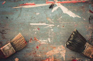 Vintage paint brushes. Old brushes on a wooden background covered with paint
