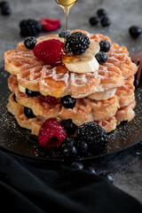 waffles with honey, blueberries, raspberries and banana