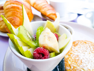 Breakfast with orange juice and fresh fruits on table