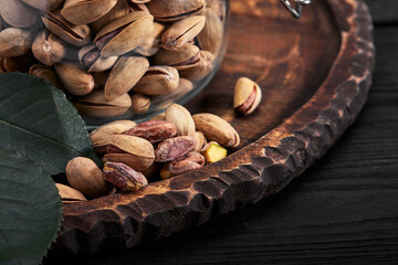 Pistachios nuts on dark background, top view, healthy snack
