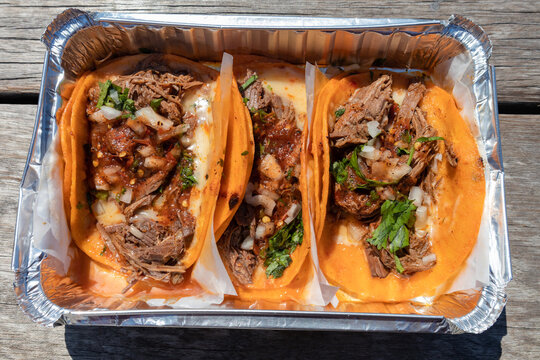 Three Beef Birria Tacos in a Takeout Container