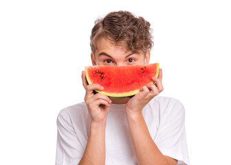 Portrait of teen boy eating ripe juicy watermelon and smiling.