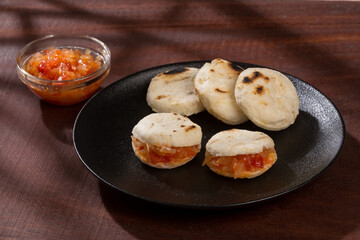 White corn arepa with hogao - tasty Colombian breakfast.