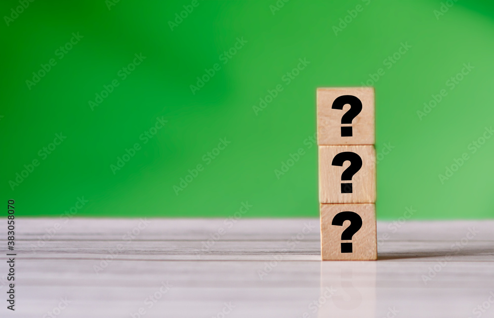 Poster three question mark sign on wooden block. stack of question mark. quiz concept background