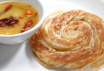 Roti canai or roti cane is a type of Indian-influenced flatbread found in Malaysia, Brunei, Indonesia and Singapore. It is often sold in Mamak stalls in Malaysia.
