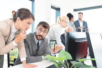 Businesswoman & colleagues in discussion at office
