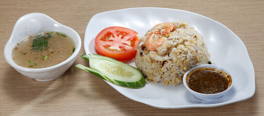 fried rice-Fried rice is a dish of cooked rice that has been stir-fried in a wok or a frying pan and is usually mixed with other ingredients such as eggs, vegetables, seafood, or meat.