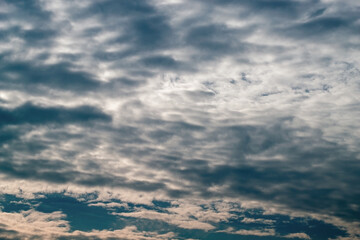 Texture of white clouds floating across the blue sky.