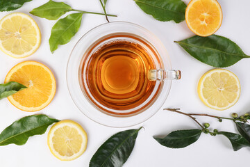 different types of fresh raw green tea leaf flower bud lemon orange slice transparent glass teacup...