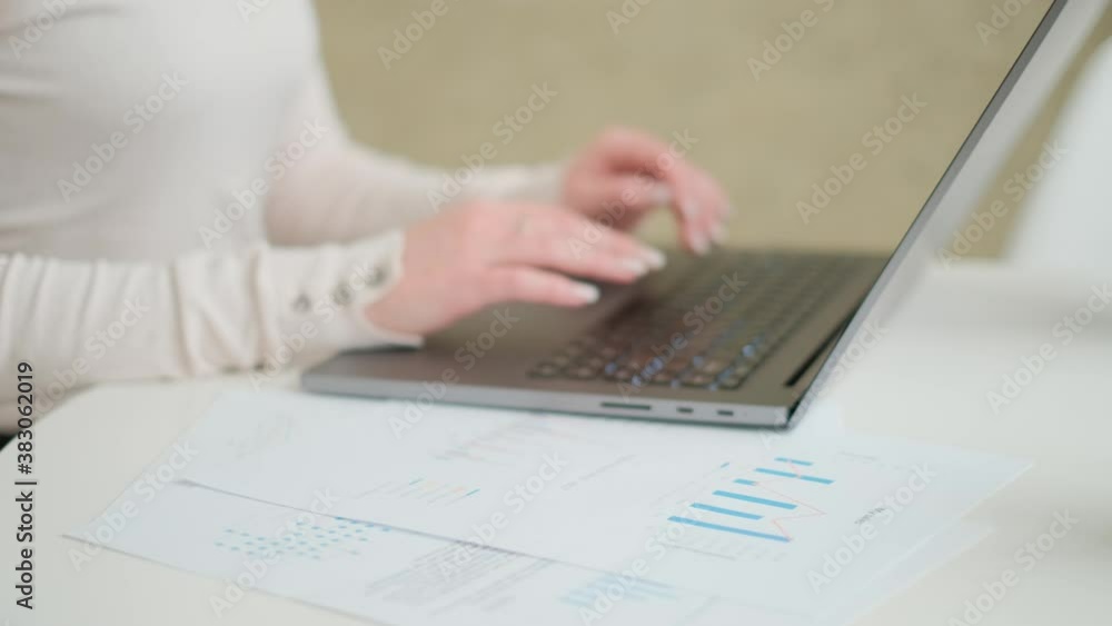 Poster remote job. a woman is working with documents on laptop remotely at home. a businesswoman man is usi