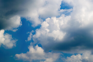 Texture of white clouds floating across the blue sky.